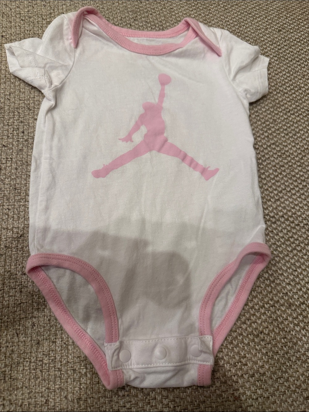 Jordan White Baby One-Piece Bodysuit with Pink Logo Trim